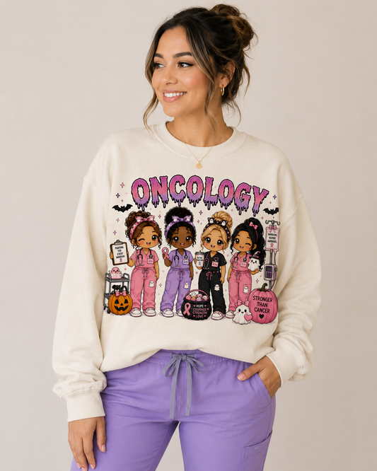Woman wearing the cream Oncology Halloween nurse sweatshirt with pink and lavender drippy lettering