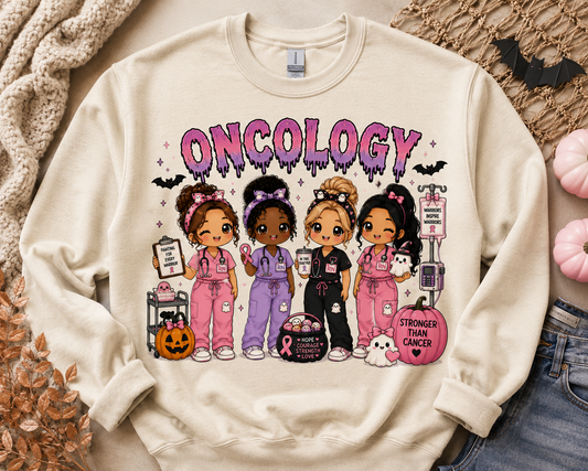 Oncology Halloween nurse sweatshirt in cream, with four chibi nurses in pink scrubs holding pink ribbons