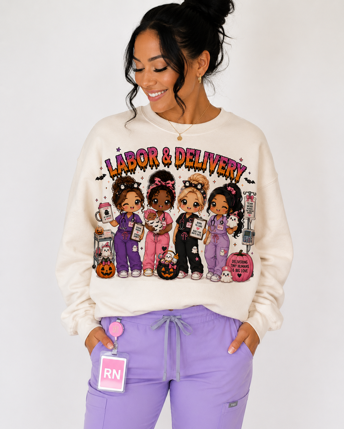 Woman wearing the cream Labor and Delivery Halloween nurse sweatshirt with pink and orange drippy lettering