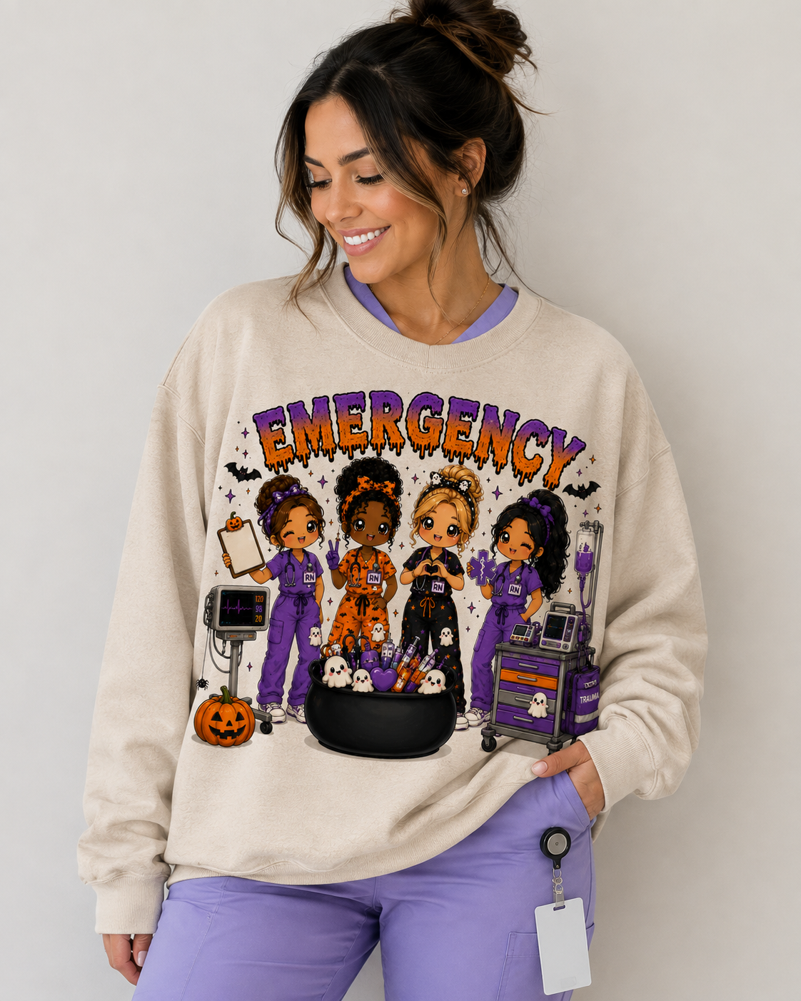 Woman wearing the cream Emergency Halloween ER nurse sweatshirt with drippy purple and orange lettering