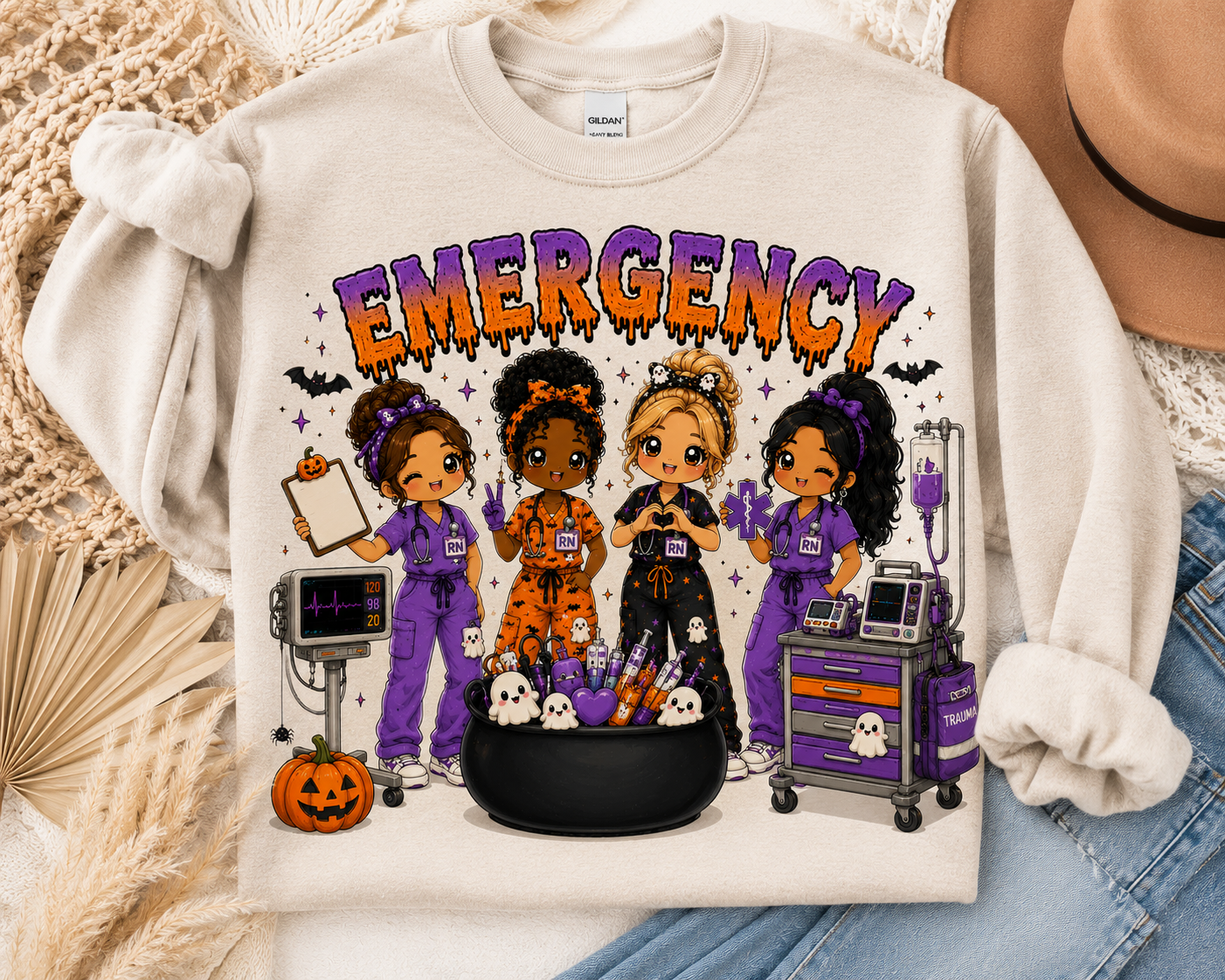 Emergency Halloween nurse sweatshirt in cream, with four chibi ER nurses, a cardiac monitor and a cauldron of syringes