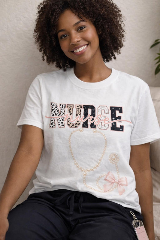 The Pearl Nurse Tee shown on a model, feminine NURSE graphic with pearl stethoscope and bow