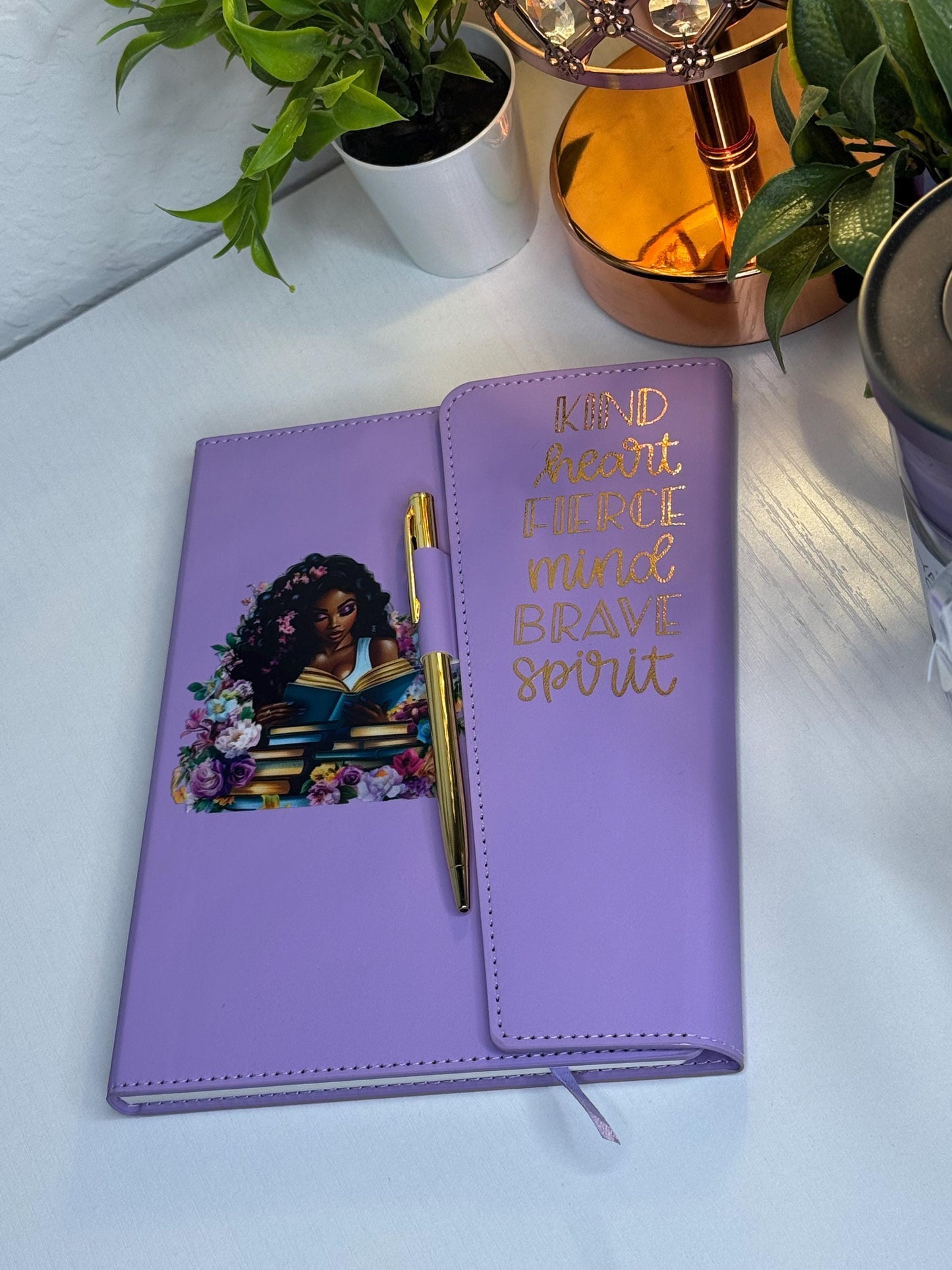 purple notebook, gold, pen, black woman, reading library book, pile, gold letter, letters