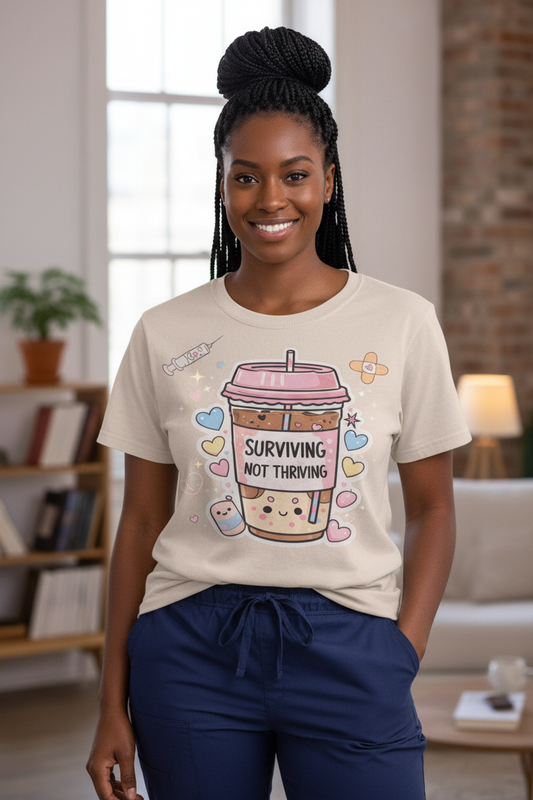 Surviving Not Thriving T-Shirt full body standing model with box braids in scrubs